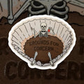 Sticker with skeleton design and 'Grounds for Concern' text on a coffee filter background