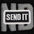 Embroidered patch with 'SEND IT' text on a textured background