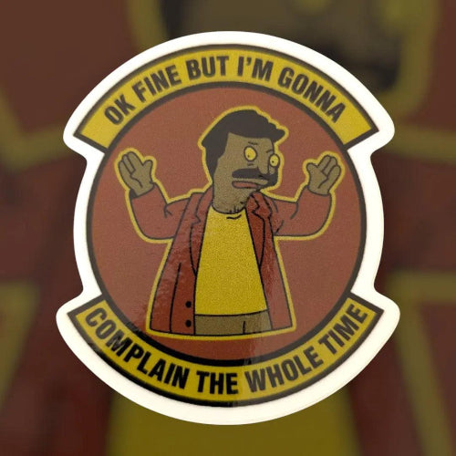 Sticker with a character and text 'OK FINE BUT I'M GONNA COMPLAIN THE WHOLE TIME' on a blurred background