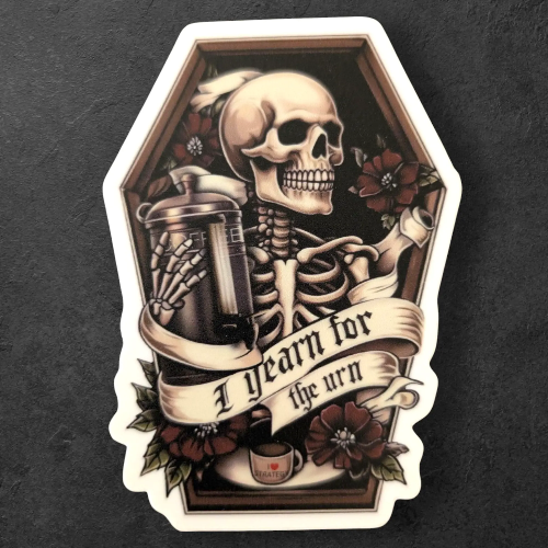 Decorative sticker with a skeleton, urn, and coffee cup on a dark background